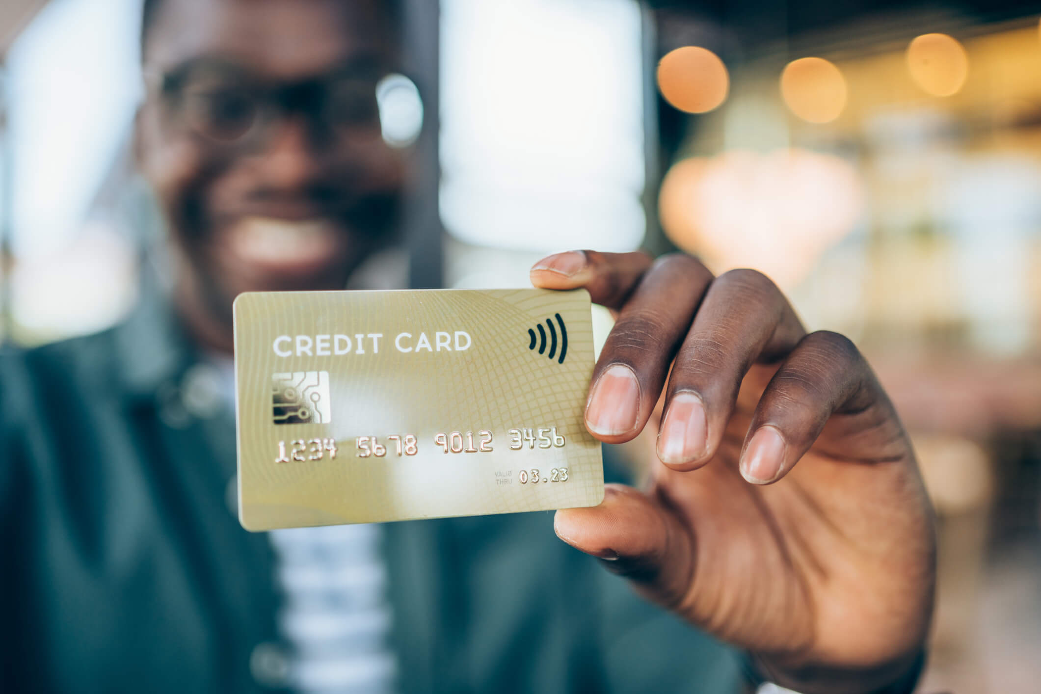 man holding up a secured credit card